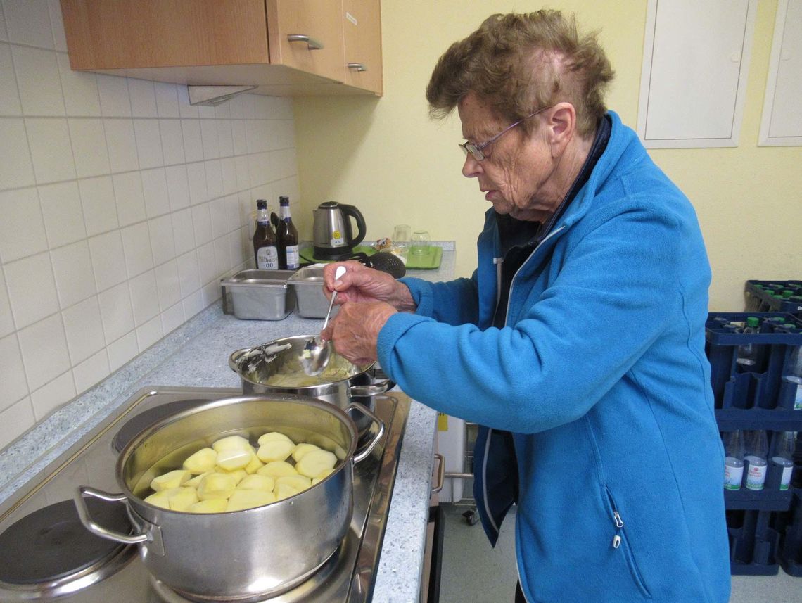 Das Bild zeigt eine Frau beim Kartoffeln kochen